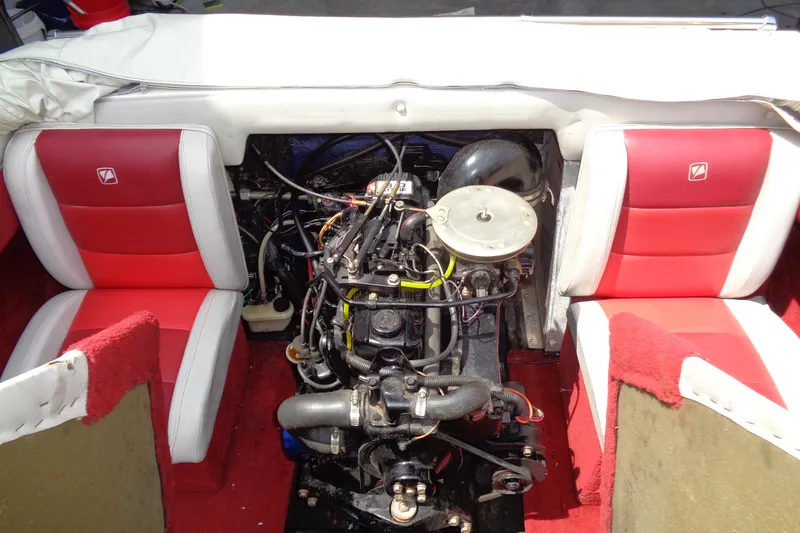 Slide: The Image of Engine compartment of a 1989 Stingray 172 SC boat with red and white seating. - 27