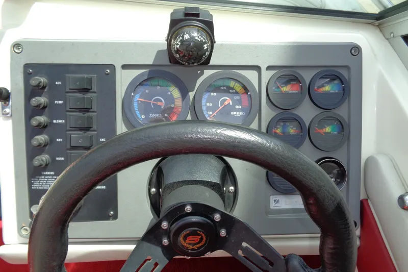 Slide: The Image of Dashboard of a 1989 Stingray 172 SC boat with steering wheel and gauges. - 14