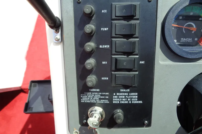Slide: The Image of Control panel of a 1989 Stingray 172 SC boat with switches and tachometer. - 24