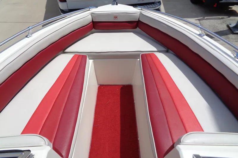 Slide: The Image of 1989 Stingray 172 SC boat interior with red and white seating and carpet. - 16