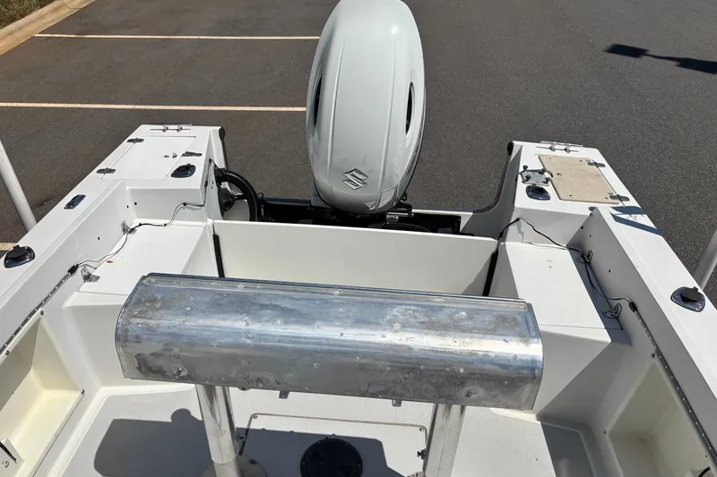Slide: The Image of 1989 Chris-Craft 213 Sea Hawk boat interior with outboard motor in parking lot. - 18