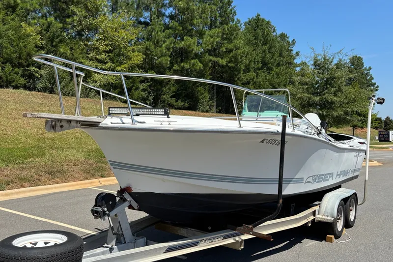 Slide: The Image of 1989 Chris-Craft 213 Sea Hawk boat on trailer, parked outdoors. - 15