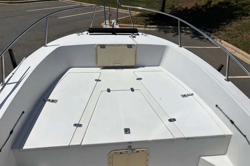 Slide: The Image of 1989 Chris-Craft 213 Sea Hawk boat deck with storage compartments, parked outdoors. - 17