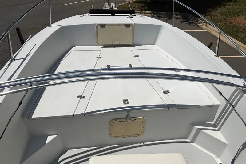 Slide: The Image of 1989 Chris-Craft 213 Sea Hawk boat interior with white deck and metal railings. - 16