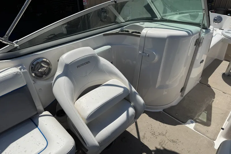 Slide: The Image of 2009 Rinker 248 Captiva Deckboat interior with white seating and speaker. - 13
