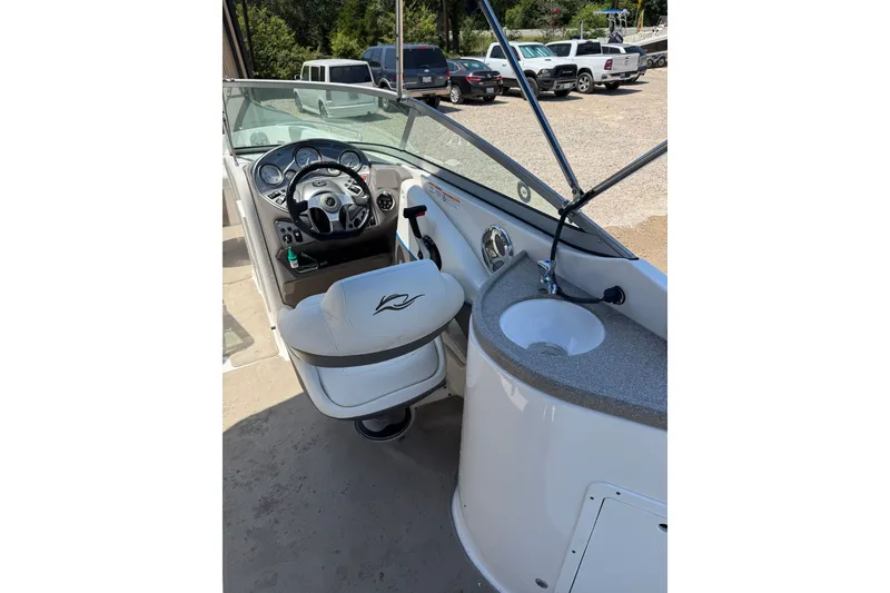 Slide: The Image of 2009 Rinker 248 Captiva Deckboat interior with steering wheel and sink. - 10