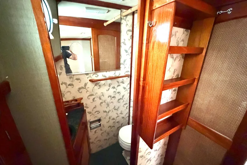 Slide: The Image of 1974 Willard Vega Voyager bathroom with wooden shelves and floral wallpaper. - 20