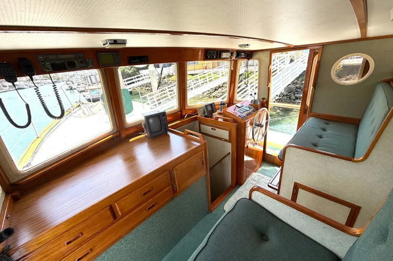 Slide: The Image of 1974 Willard Vega Voyager boat interior with wooden helm, seating, and navigation equipment. - 13