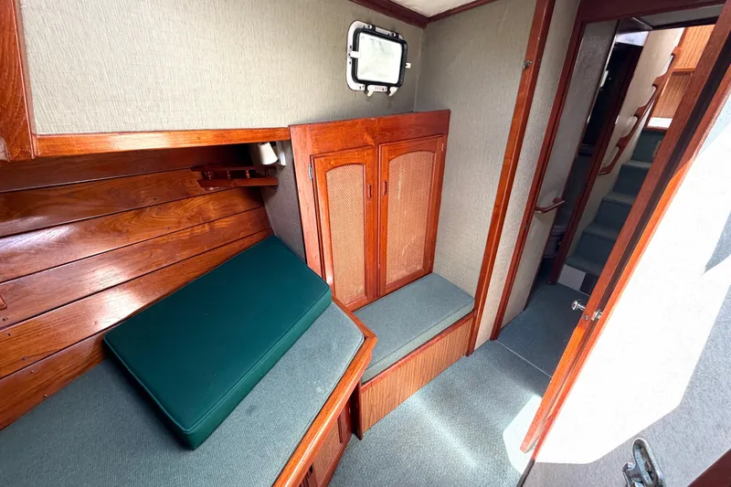 Slide: The Image of 1974 Willard Vega Voyager interior with wooden paneling and green cushions. - 18