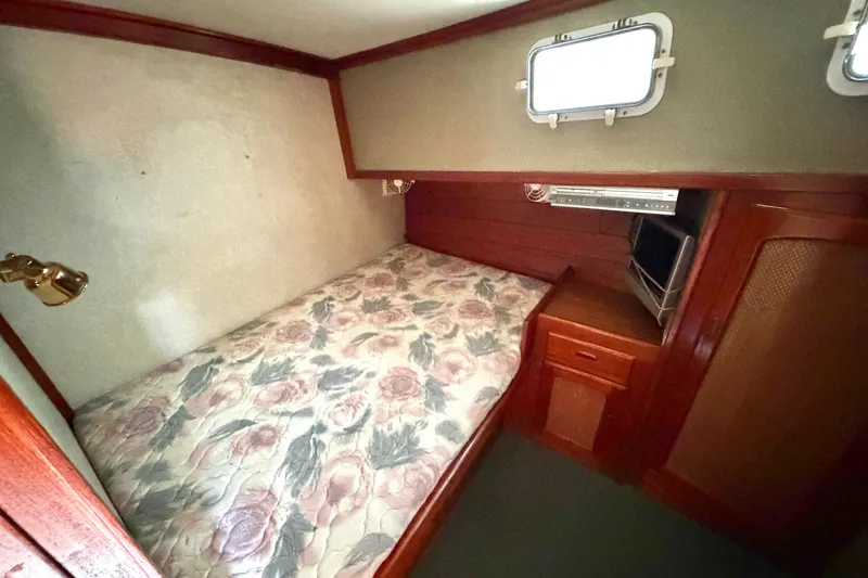 Slide: The Image of Cozy cabin interior of 1974 Willard Vega Voyager with floral bedding and wooden furnishings. - 17