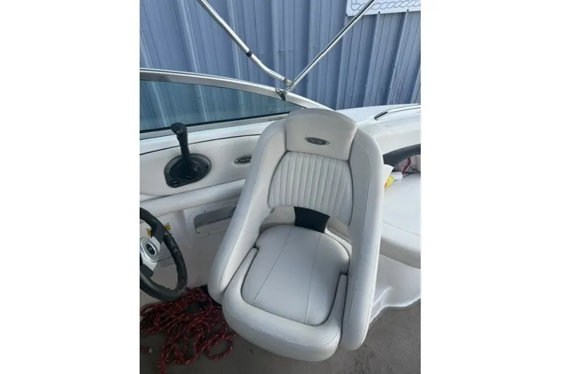 Slide: The Image of 2003 Chaparral 265 SSi boat interior with white captain's chair and steering wheel. - 9