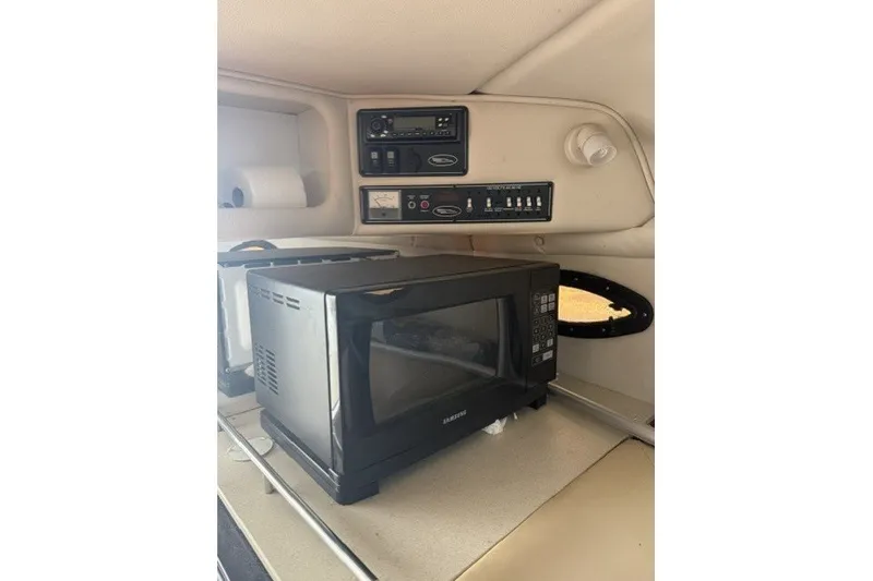Slide: The Image of 2003 Chaparral 265 SSi cabin interior with microwave and control panel. - 5