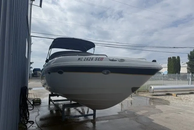 Slide: The Image of 2003 Chaparral 265 SSi boat on trailer, parked outdoors under cloudy sky. - 1