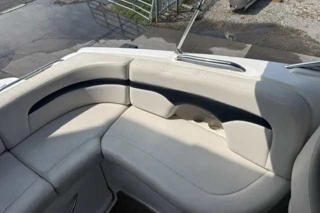 Slide: The Image of 2003 Chaparral 265 SSi boat interior with white cushioned seating. - 15