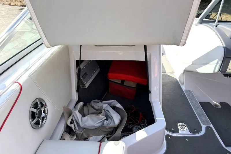 Slide: The Image of 2008 Correct Craft Super Air Nautique 210 storage compartment with speaker and equipment. - 32
