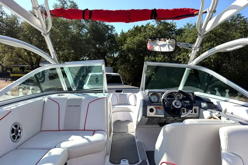 Slide: The Image of 2008 Correct Craft Super Air Nautique 210 interior with white seating and dashboard view. - 29