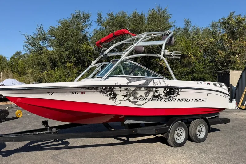 Slide: The Image of 2008 Correct Craft Super Air Nautique 210 boat on trailer, red and white design. - 14