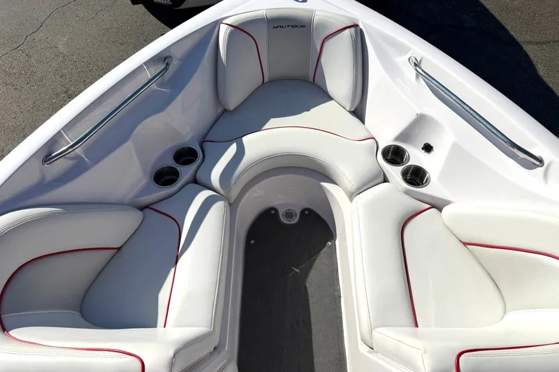 Slide: The Image of 2008 Correct Craft Super Air Nautique 210 boat interior with white seating and cup holders. - 38