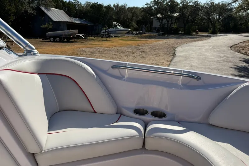 Slide: The Image of 2008 Correct Craft Super Air Nautique 210 boat interior with white seating and cup holders. - 42