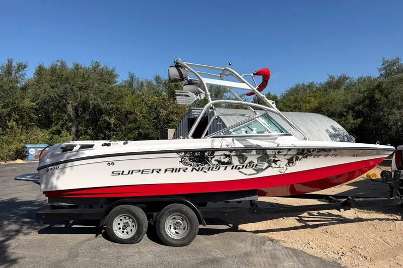 Slide: The Image of 2008 Correct Craft Super Air Nautique 210 boat on trailer, parked outdoors. - 7