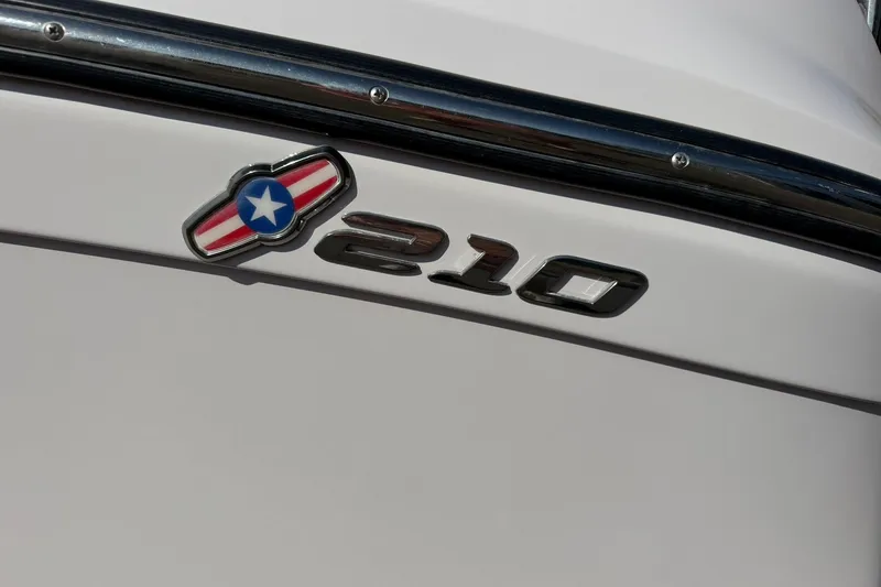 Slide: The Image of 2008 Correct Craft Super Air Nautique 210 emblem on white boat exterior. - 48