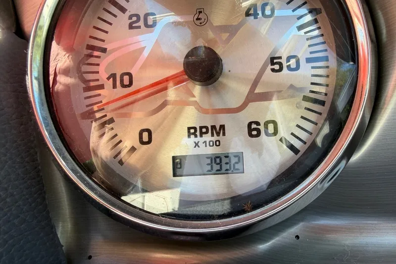 Slide: The Image of Close-up of 2008 Correct Craft Super Air Nautique 210 RPM gauge displaying 393.2 hours. - 36