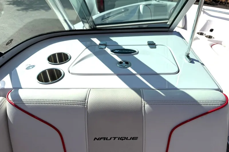 Slide: The Image of 2008 Correct Craft Super Air Nautique 210 boat interior with cup holders and storage compartment. - 31
