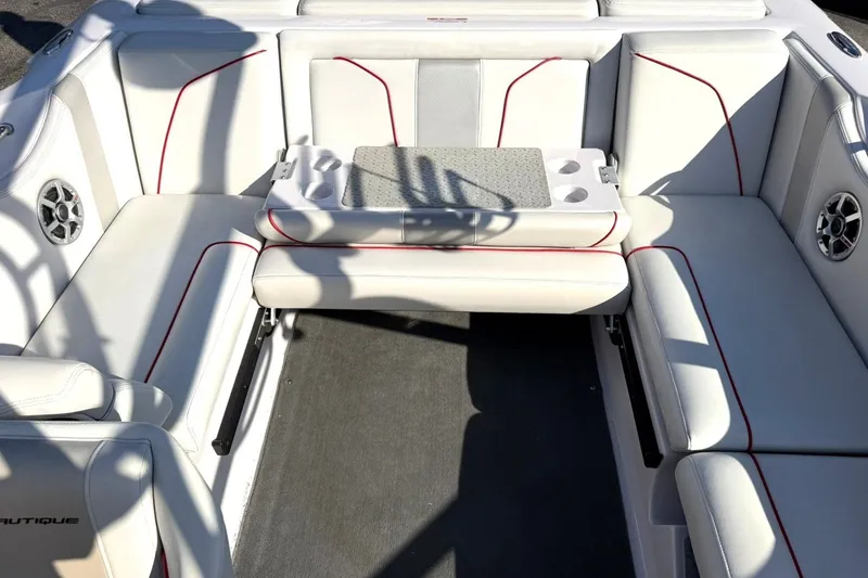 Slide: The Image of 2008 Correct Craft Super Air Nautique 210 interior with white seating and red accents. - 26