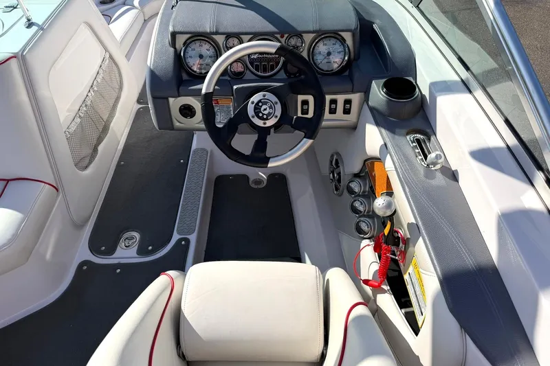 Slide: The Image of 2008 Correct Craft Super Air Nautique 210 boat interior with steering wheel and dashboard controls. - 34