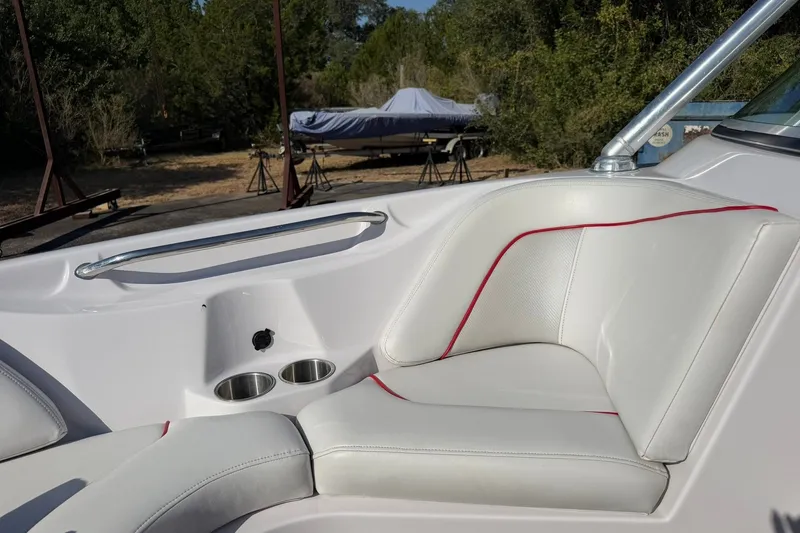 Slide: The Image of 2008 Correct Craft Super Air Nautique 210 interior with white seating and cup holders. - 41