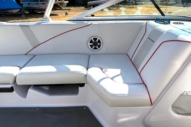 Slide: The Image of 2008 Correct Craft Super Air Nautique 210 interior with white seating and red accents. - 30