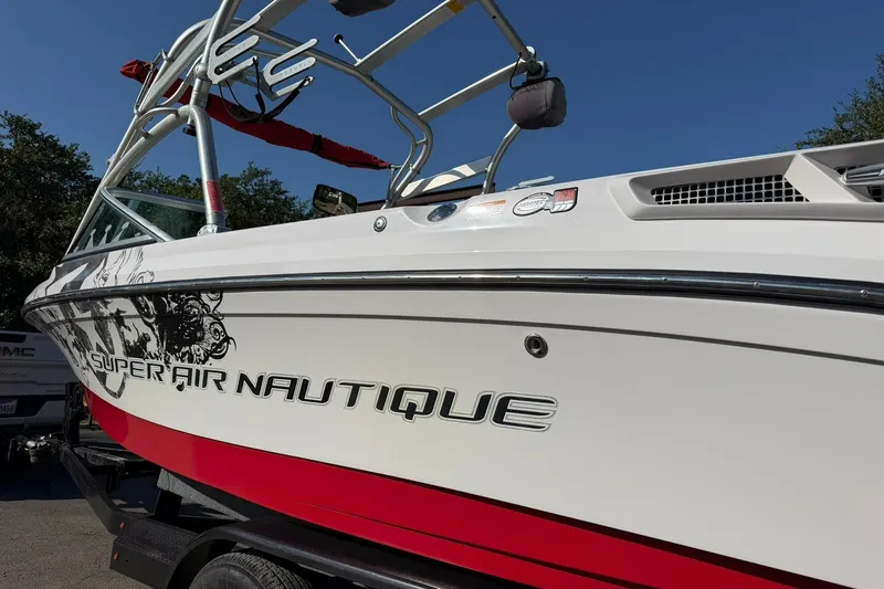 Slide: The Image of 2008 Correct Craft Super Air Nautique 210 boat with red and white design. - 18