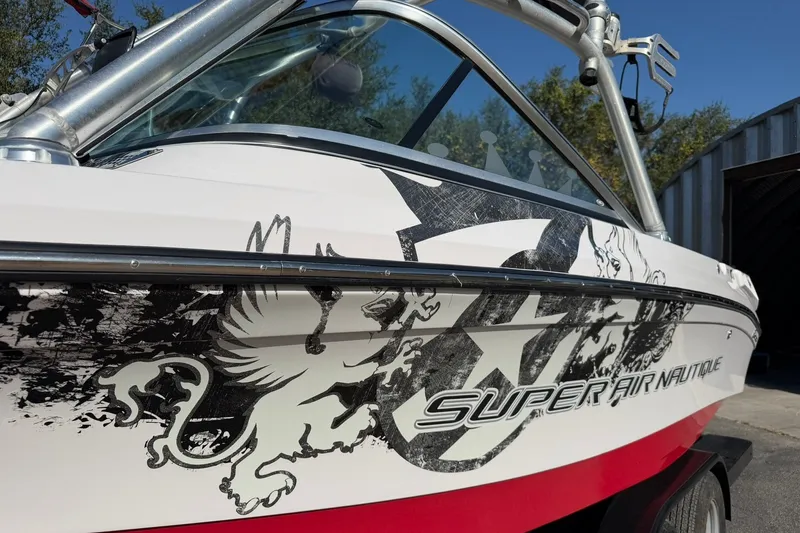 Slide: The Image of 2008 Correct Craft Super Air Nautique 210 boat with bold graphics and sleek design. - 15
