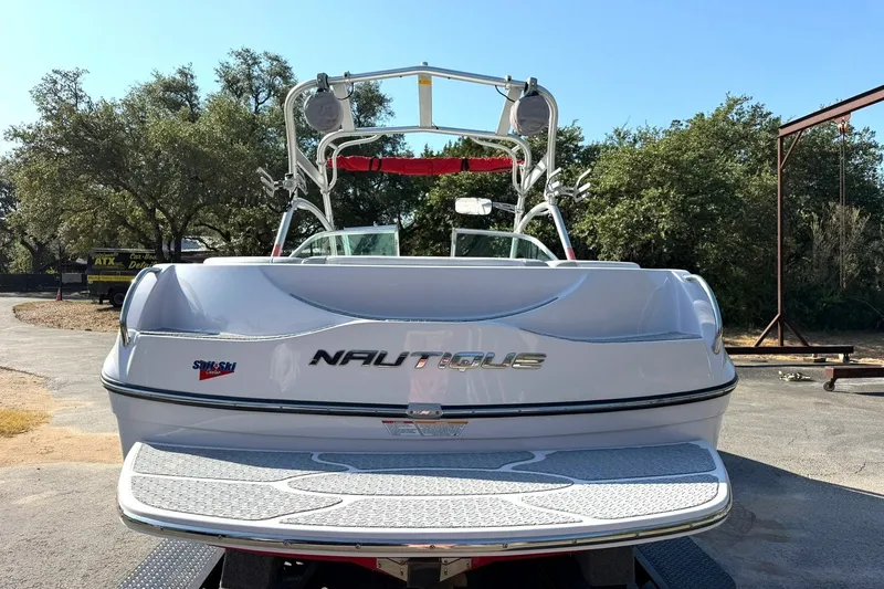 Slide: The Image of 2008 Correct Craft Super Air Nautique 210 boat, rear view, parked outdoors. - 19