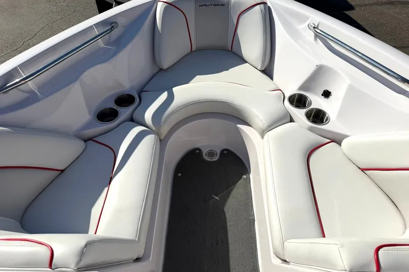 Slide: The Image of 2008 Correct Craft Super Air Nautique 210 boat interior with white seating and cup holders. - 6
