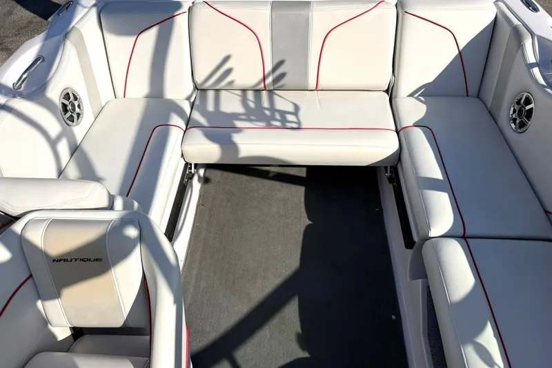 Slide: The Image of 2008 Correct Craft Super Air Nautique 210 interior with white seating and red accents. - 25