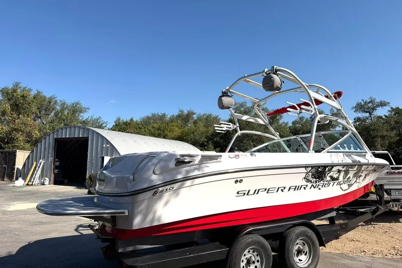 Slide: The Image of 2008 Correct Craft Super Air Nautique 210 boat on trailer, parked outdoors. - 12