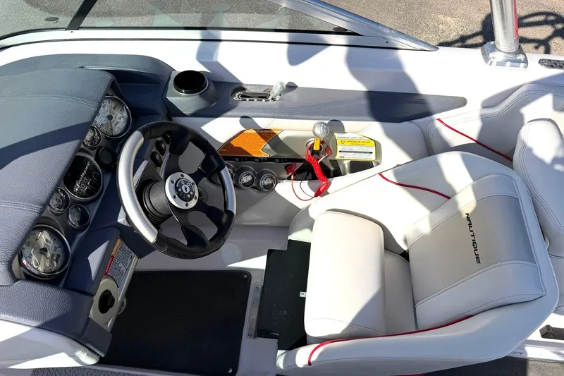 Slide: The Image of 2008 Correct Craft Super Air Nautique 210 cockpit with steering wheel and gauges. - 5