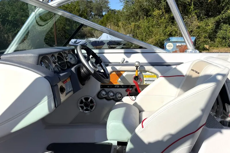 Slide: The Image of Interior of 2008 Correct Craft Super Air Nautique 210 boat, featuring steering wheel and dashboard. - 33