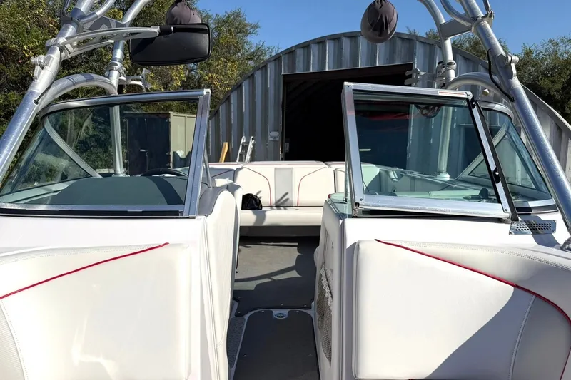 Slide: The Image of 2008 Correct Craft Super Air Nautique 210 interior with open windshield and seating. - 43