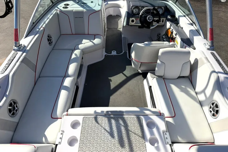 Slide: The Image of Interior of 2008 Correct Craft Super Air Nautique 210 boat with spacious seating and modern dashboard. - 23