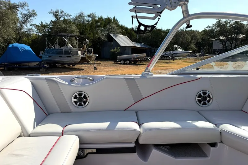 Slide: The Image of 2008 Correct Craft Super Air Nautique 210 interior with white seating and red accents. - 28