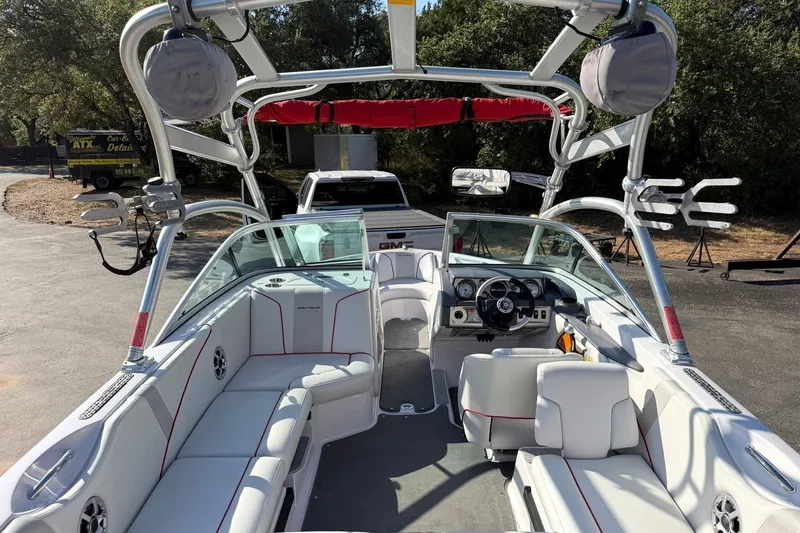 Slide: The Image of 2008 Correct Craft Super Air Nautique 210 boat interior with white seating and sleek dashboard. - 24