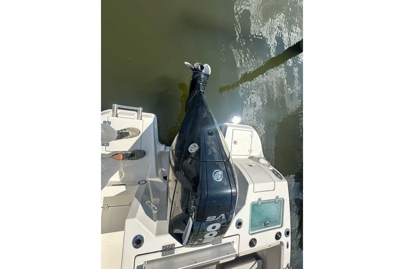 Slide: The Image of 2024 Sailfish 226 DC boat with powerful outboard motor on calm water. - 12