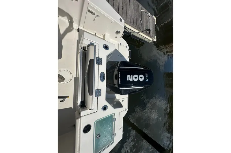 Slide: The Image of 2024 Sailfish 226 DC boat with Mercury 200 V6 engine at dockside. - 10