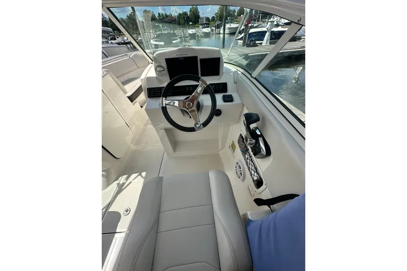 Slide: The Image of 2024 Sailfish 226 DC boat interior with steering wheel and control panel. - 8