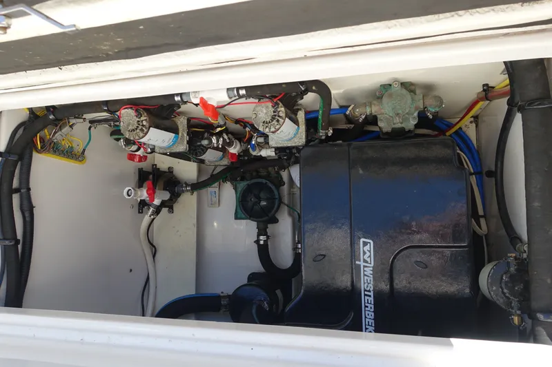 Slide: The Image of Engine compartment of a 2017 Robalo R305 Walkaround boat with Westerbeke generator. - 28