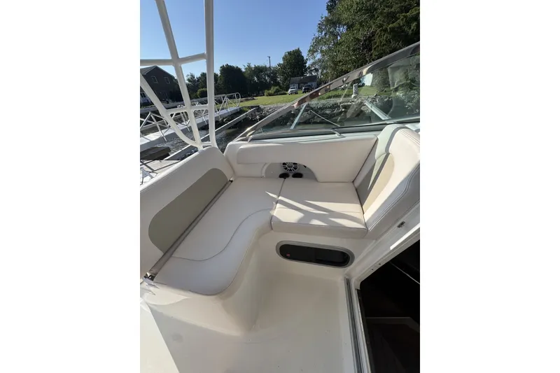 Slide: The Image of 2017 Robalo R305 Walkaround boat interior with cushioned seating and clear windshield. - 23