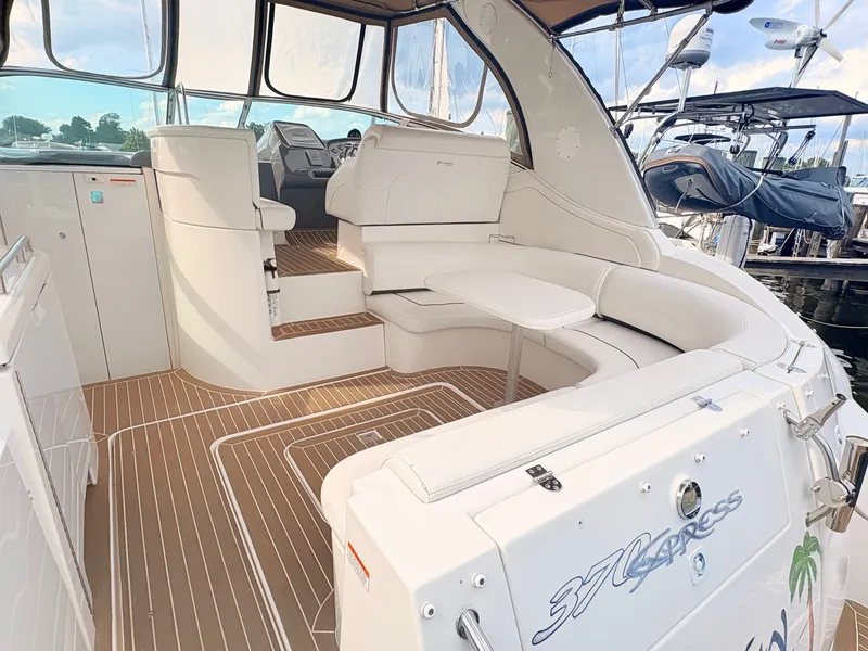 Slide: The Image of The image shows the cockpit of a 2007 Cruisers 37O Express with white seating and wood flooring. - 10