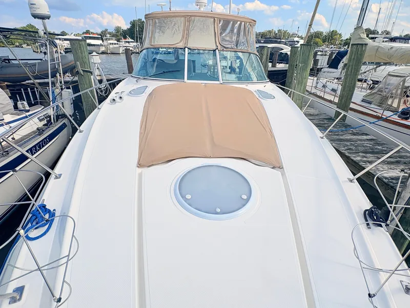 Slide: The Image of The 2007 Cruisers 37O Express is docked, featuring a beige sun deck. - 7